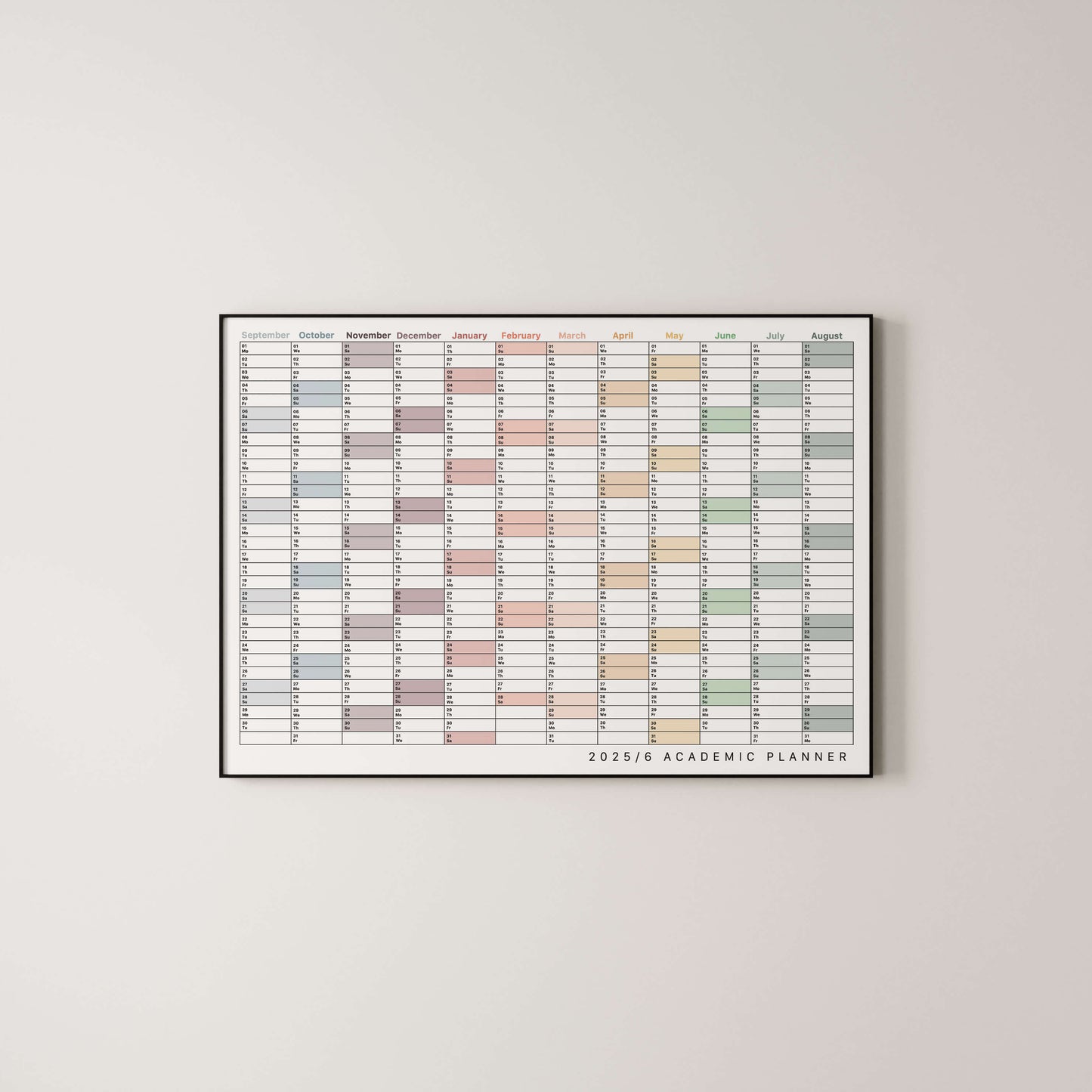 Framed academic wall planner with colourful grid on a light gray wall