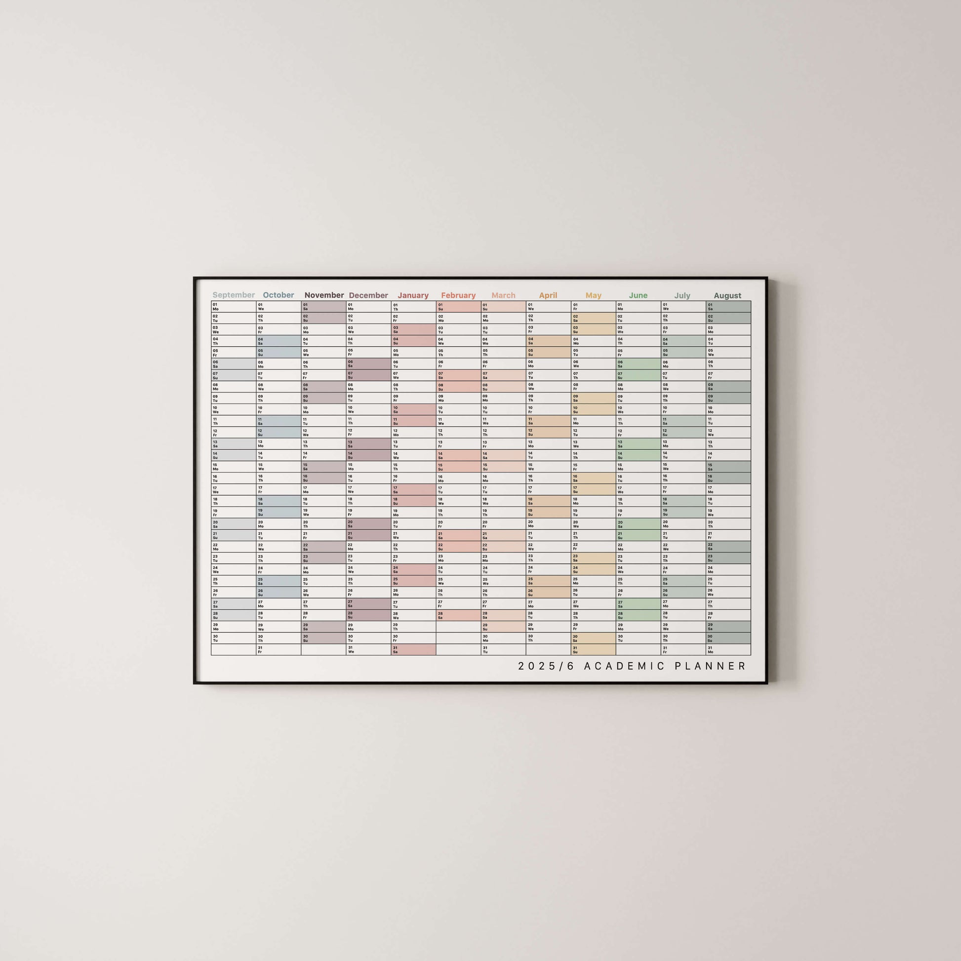 Framed academic wall planner with colourful grid on a light gray wall
