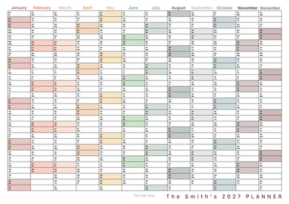 A personalised 2027 wall calendar. The calendar features columns for each month from January to December, with pastel-coloured blocks highlighting days across the year.