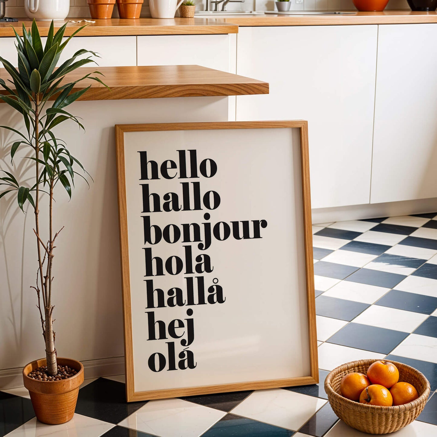 Framed poster with 'hello hallo bonjour hola hallö hej ola' text in a kitchen setting.