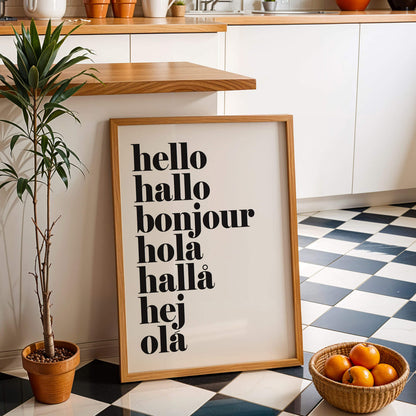 Framed poster with 'hello hallo bonjour hola hallö hej ola' text in a kitchen setting.