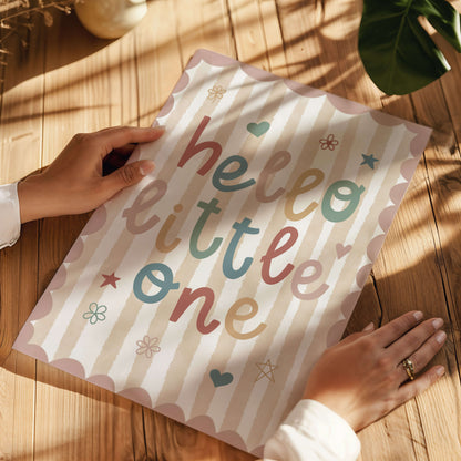 Children's nursery print with 'hello little one' text on a striped background with pink scalloped border.
