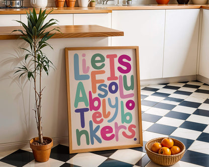 Life is bonkers typography print in a wooden frame in a kitchen.