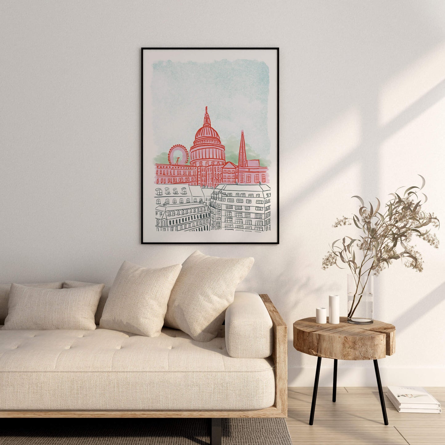 Framed artwork of an illustration of London on a wall above a sofa in a living room.