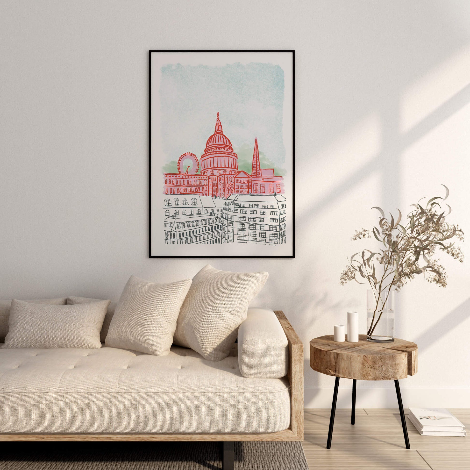 Framed artwork of an illustration of London on a wall above a sofa in a living room.