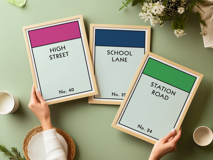Three framed Monopoly style street name prints in wooden frames.