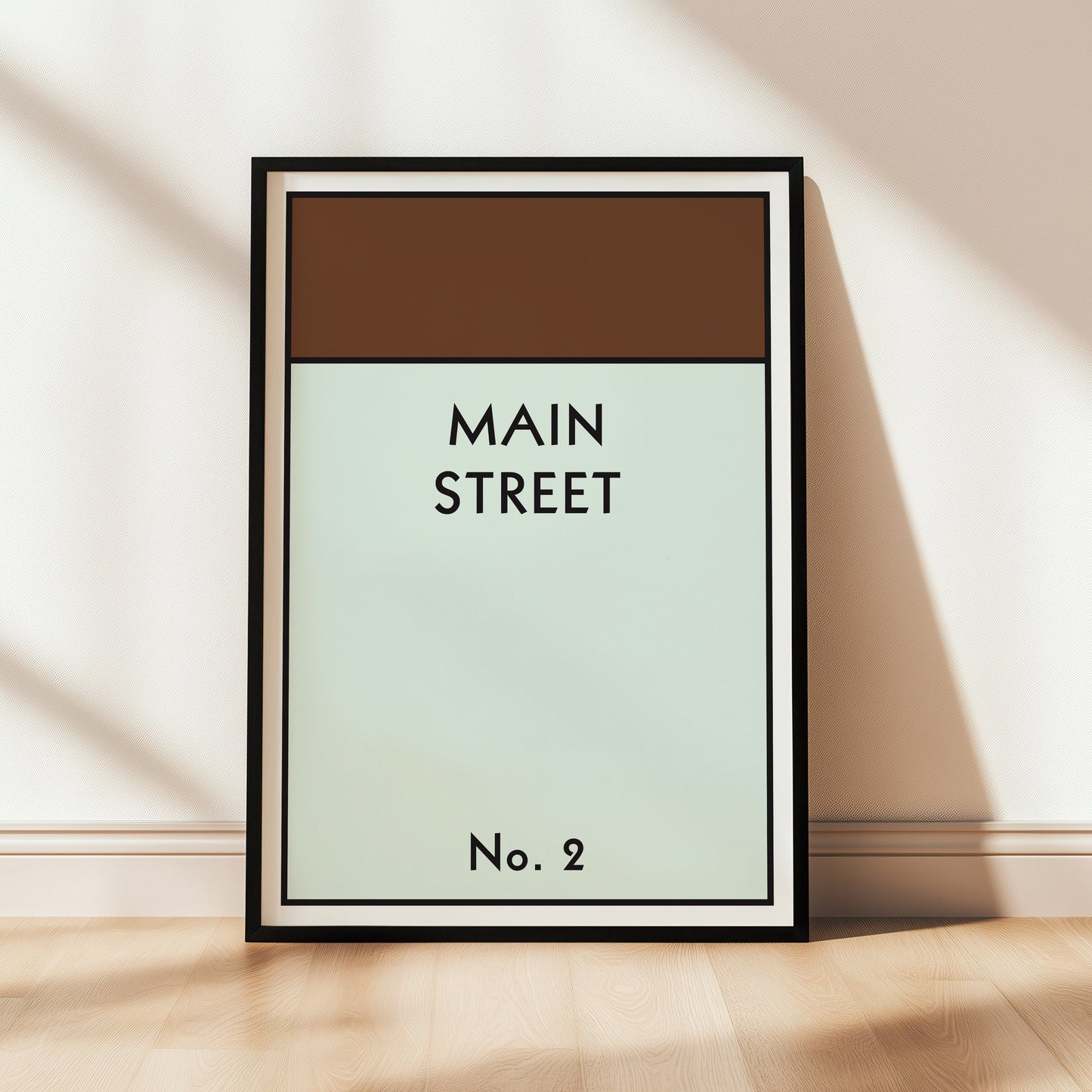 Framed artwork with 'MAIN STREET' and 'No. 2' text on a light background