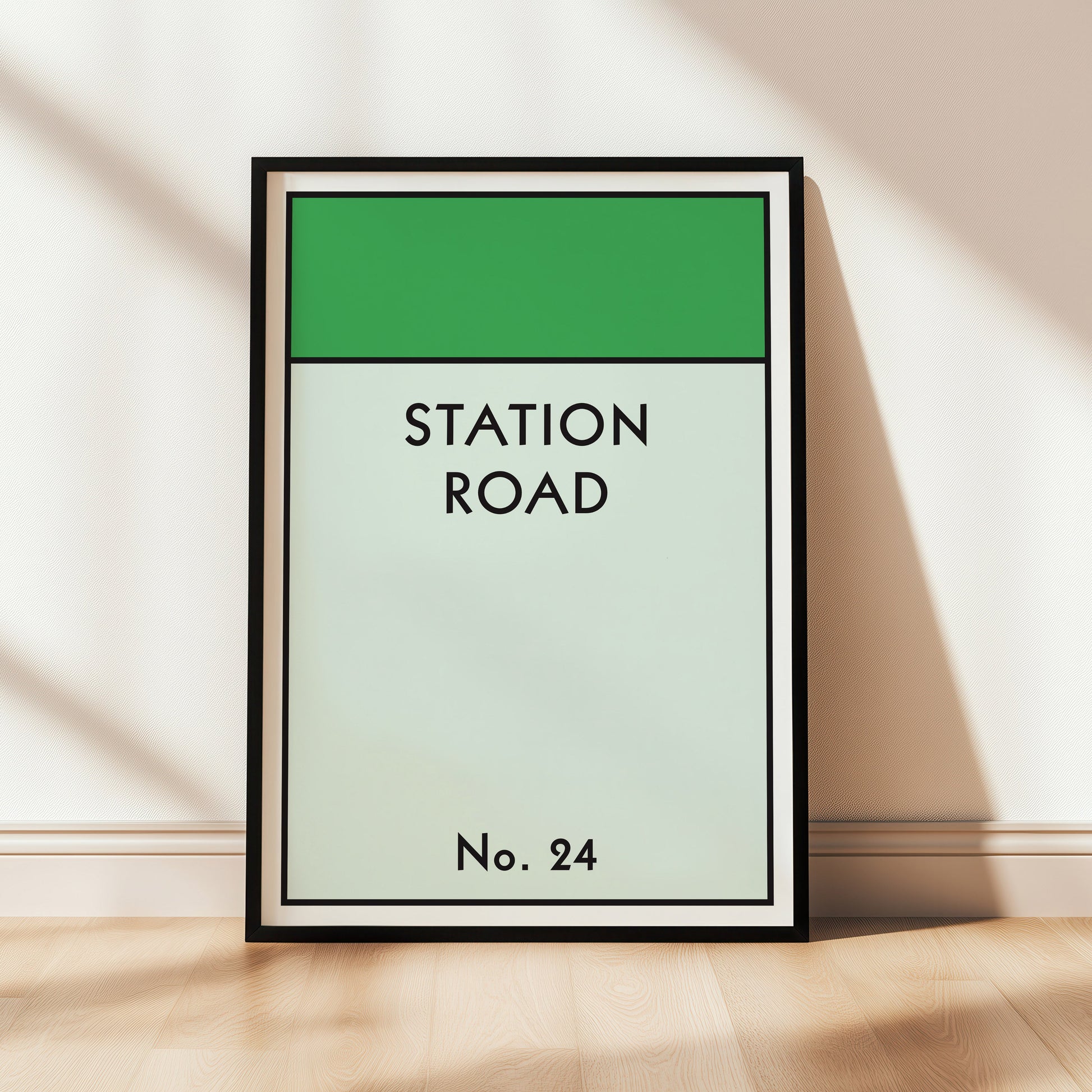 Framed artwork with 'Station Road No. 24' text on a green and light gray background