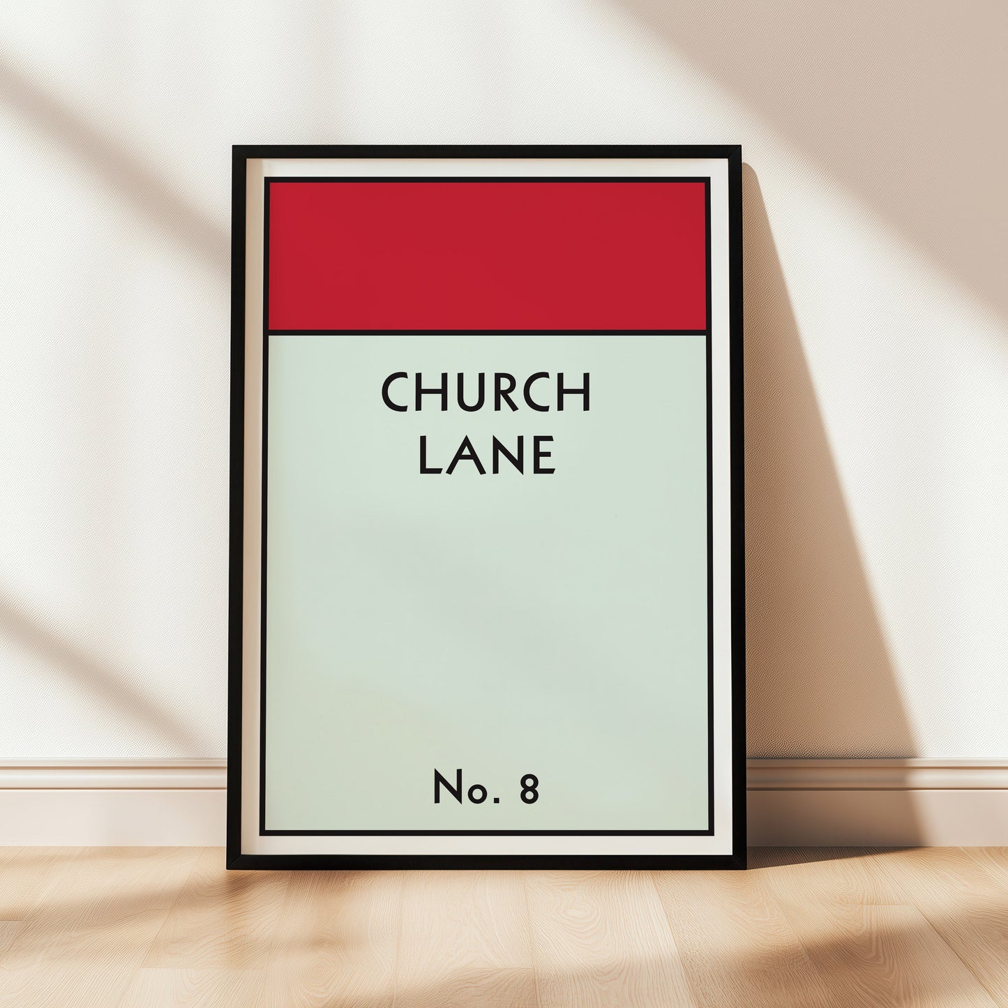 Monopoly style framed artwork with 'Church Lane' text on a red and light green gradient background