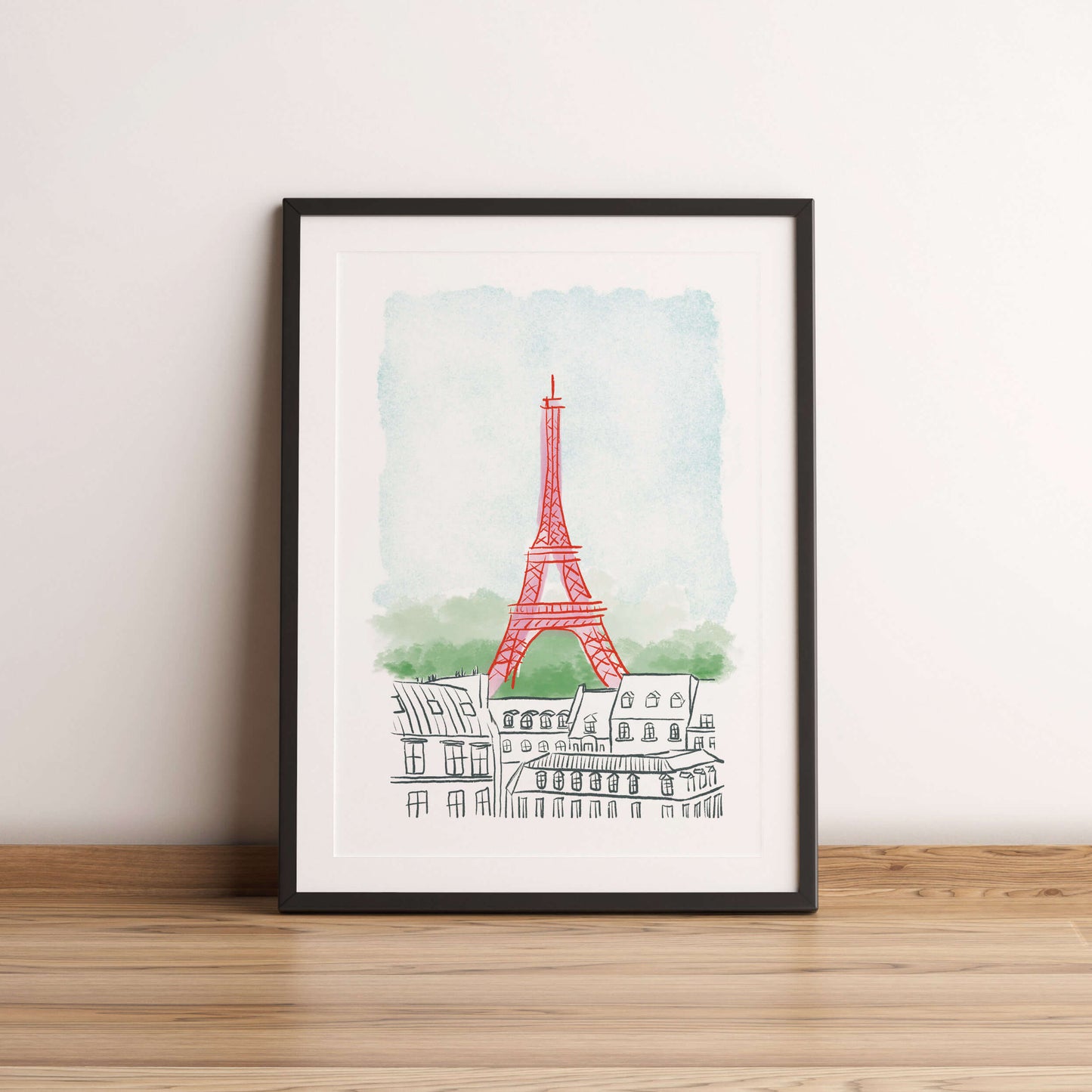 Framed artwork of the Eiffel Tower on a white wall.
