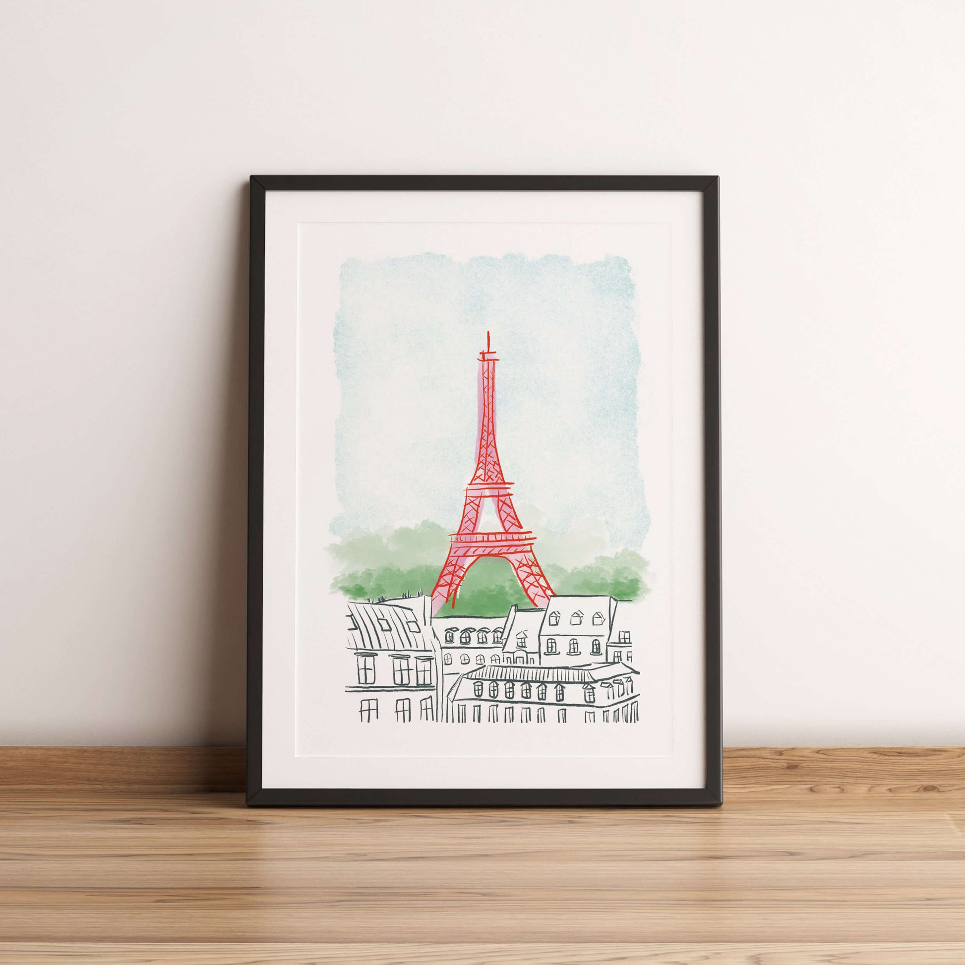 Framed artwork of the Eiffel Tower on a white wall.