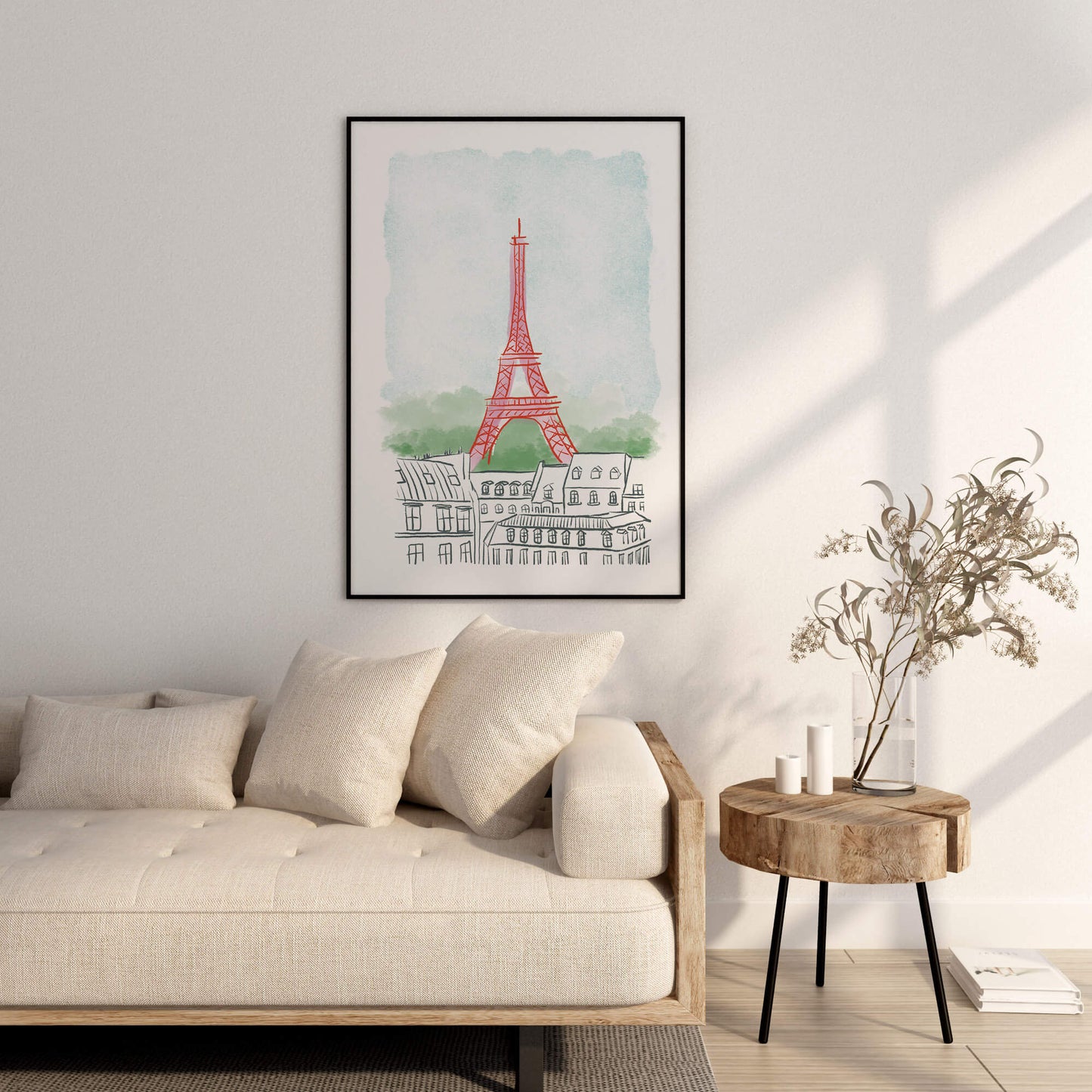 Framed artwork of the Eiffel Tower on a wall above a sofa in a living room.