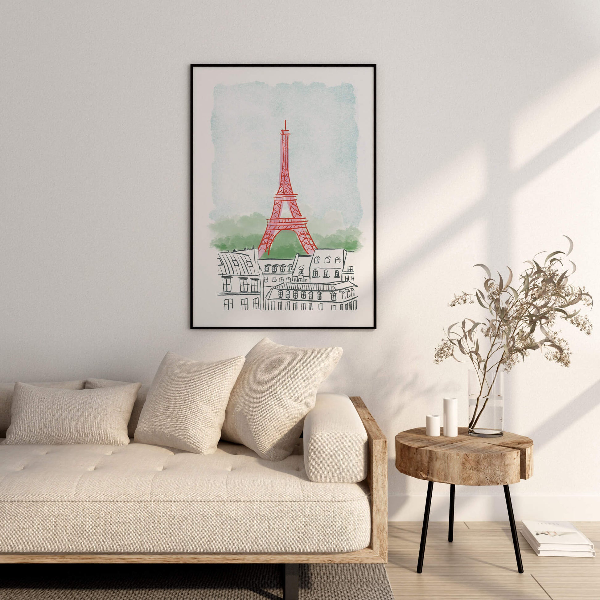 Framed artwork of the Eiffel Tower on a wall above a sofa in a living room.