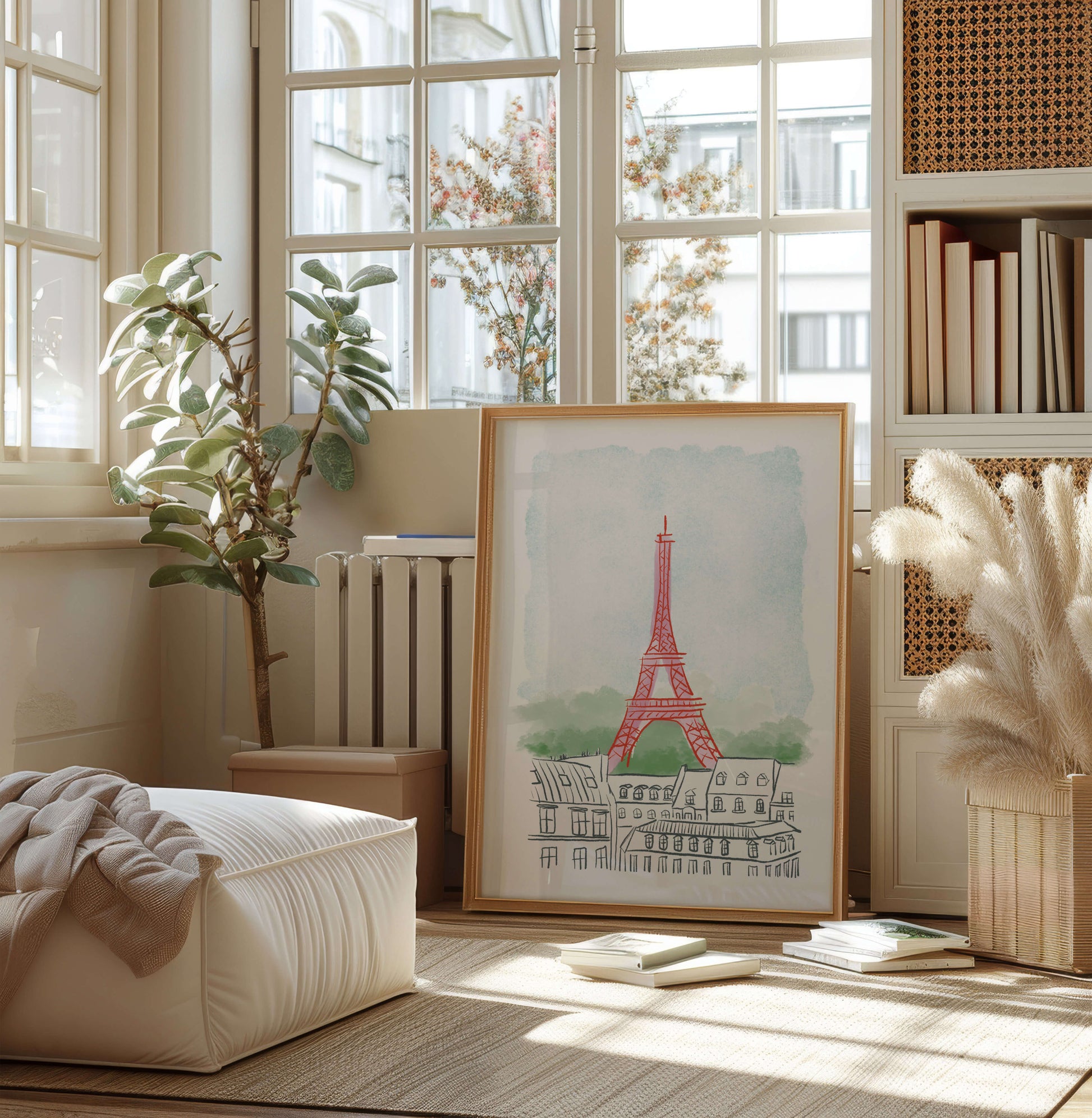 Framed artwork of the Eiffel Tower in a bright room with books and plants.