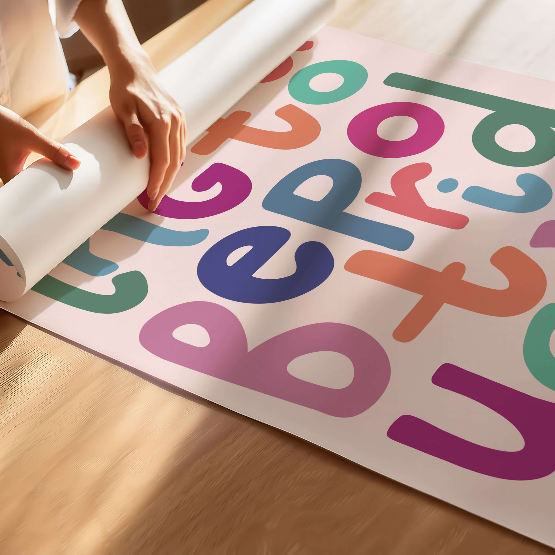 Lady rolling up a bright typography poster