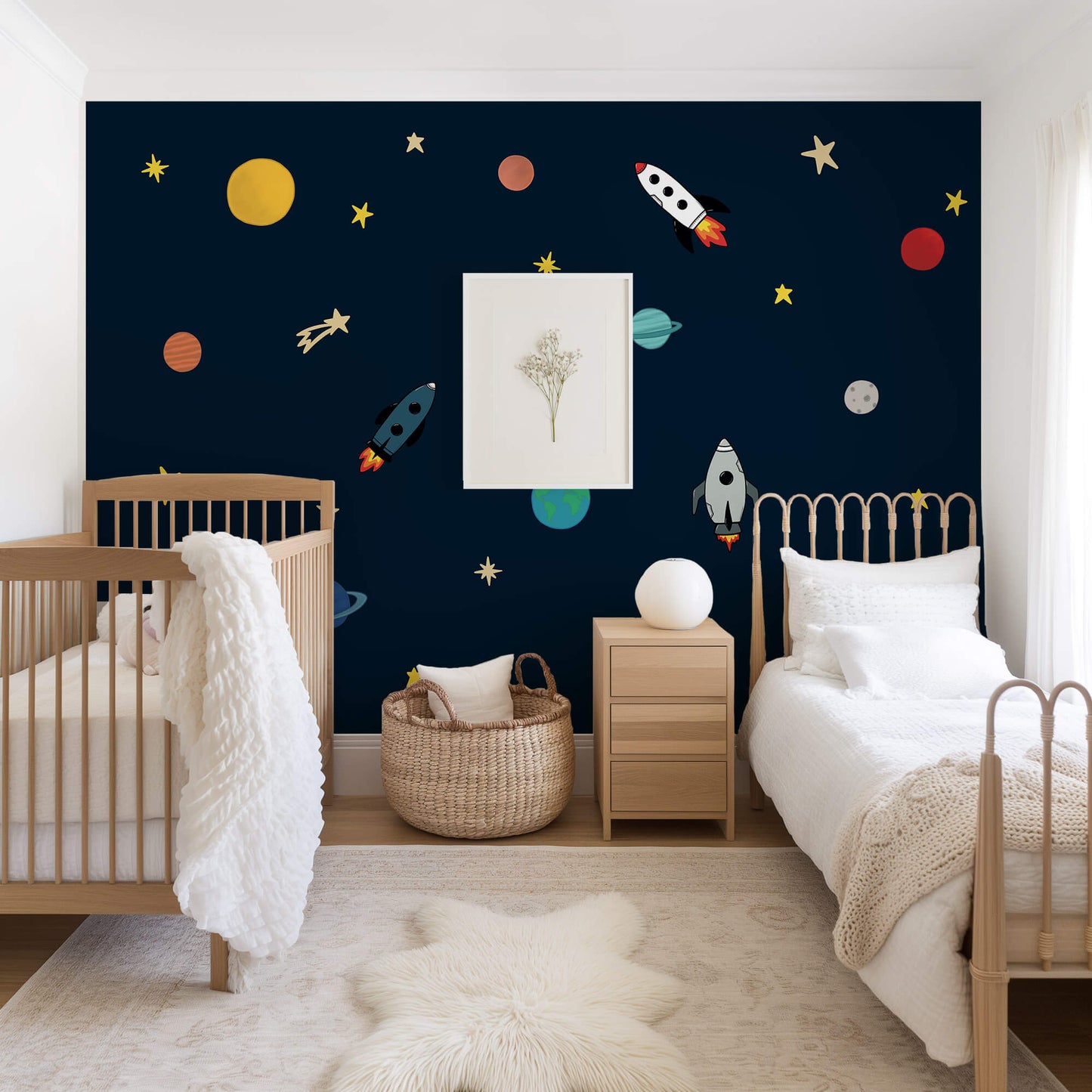 Children's bedroom with space-themed wallpaper, crib, and bed.