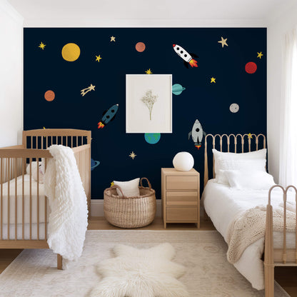 Children's bedroom with space-themed wallpaper, crib, and bed.