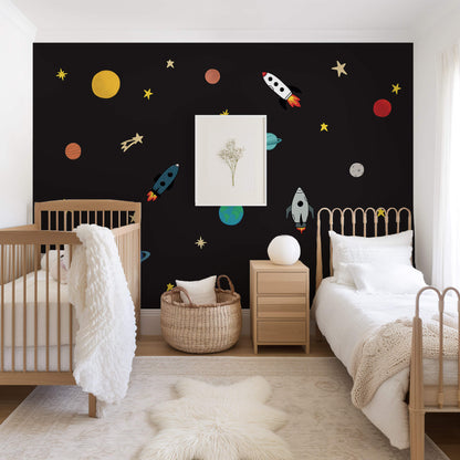 Children's bedroom with space-themed wall stickers.