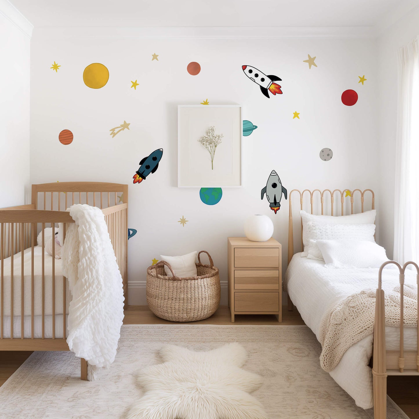 Children's bedroom with space-themed wall decals, wooden crib, and bed.