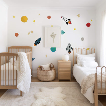 Children's bedroom with space-themed wall decals, wooden crib, and bed.