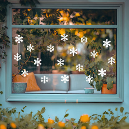Decorative window with snowflake decals and a view of a living room.
