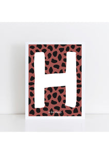 Dalmatian Spot Initial Print - brick/black background